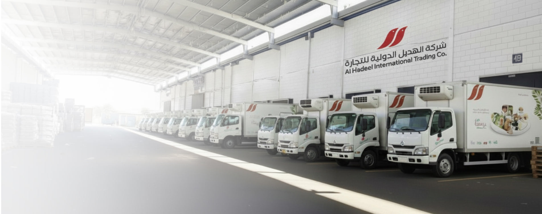 Alhadeel International Trading Company, Saudi Arabia. Row of trucks with a visible logo in a warehouse setting